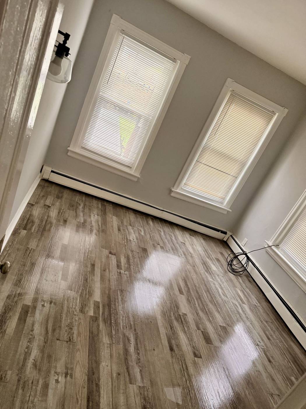 Empty room with gleaming floors after a move-in or move-out clean