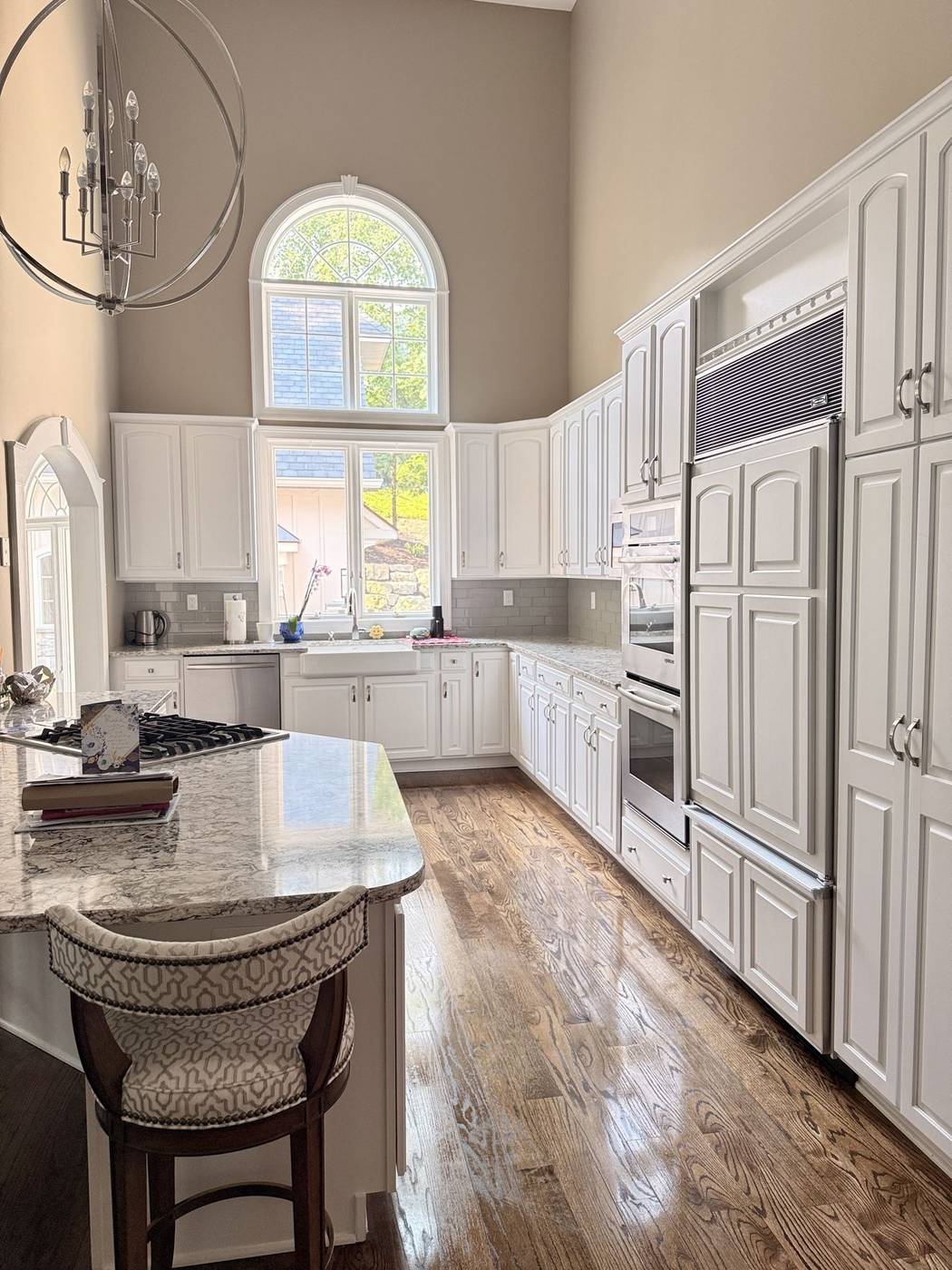 Bright white kitchen with gleaming floors and countertops