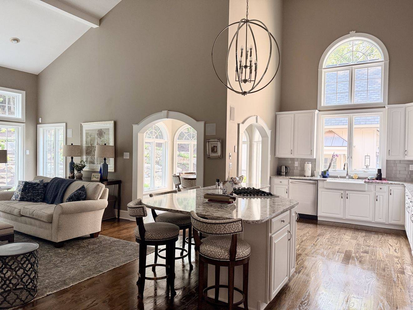 Clean open-plan kitchen with a polished island and floors
