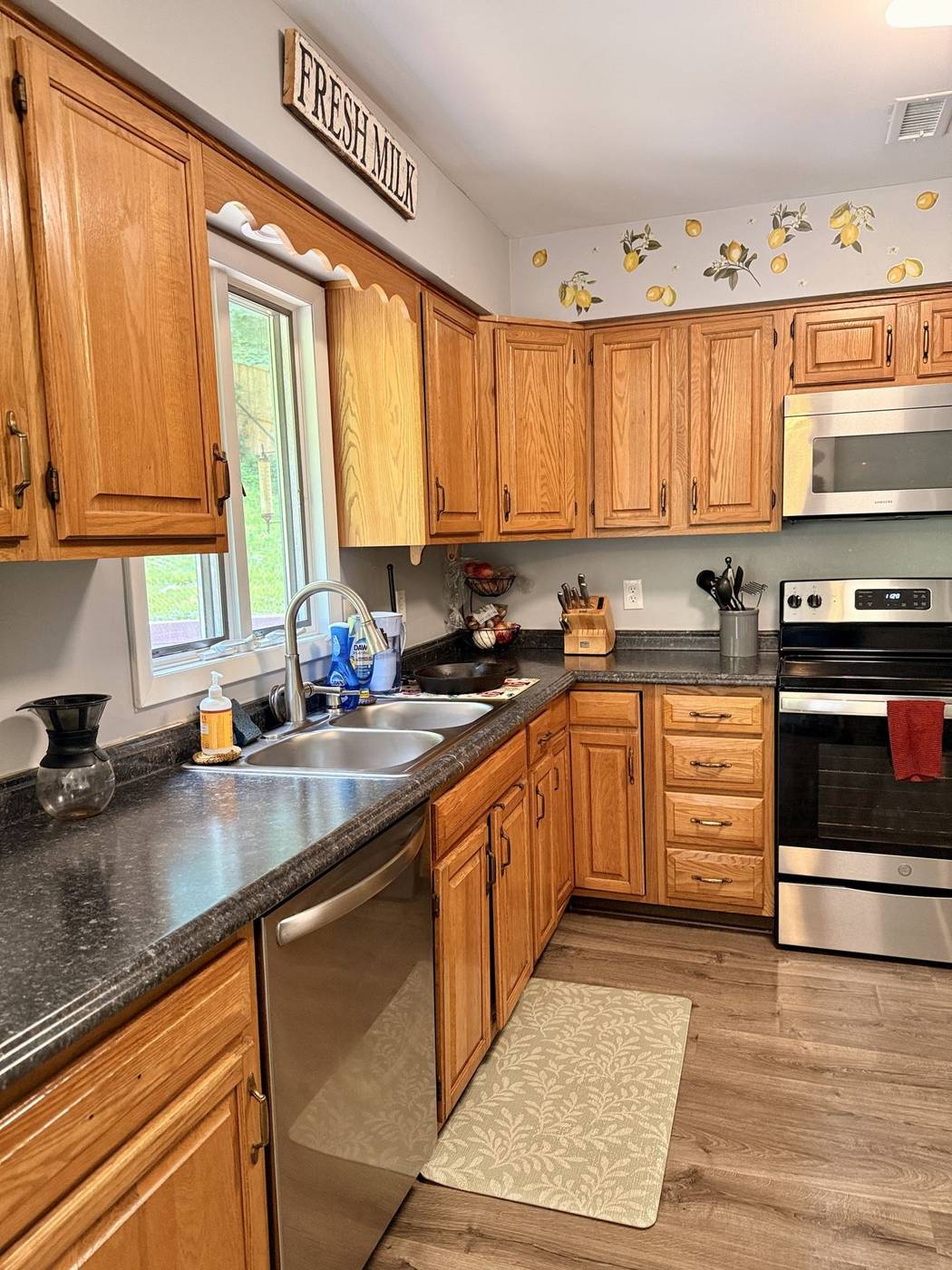 Cleaned kitchen counter, sink, and wood cabinets
