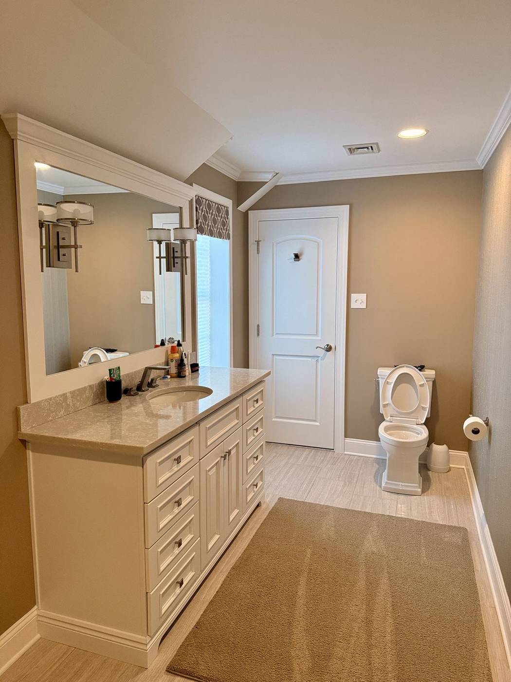 Clean bathroom with a long vanity and polished fixtures