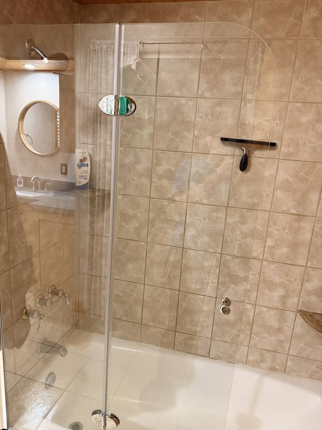 Spotless tiled cabin shower with clear glass doors
