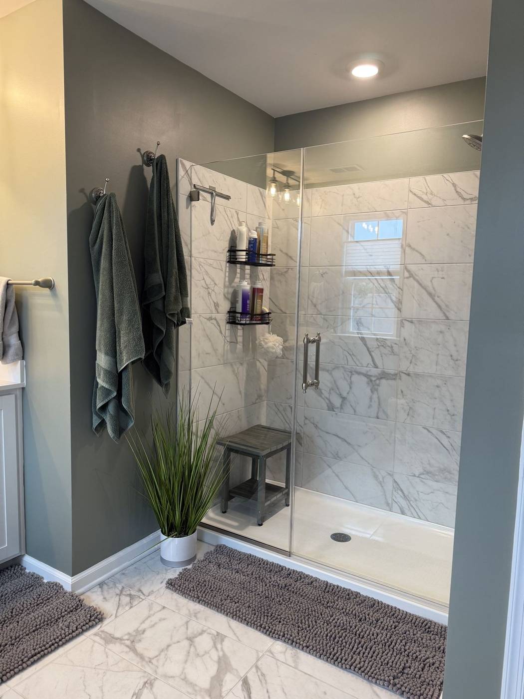 Clean marble shower with polished fixtures