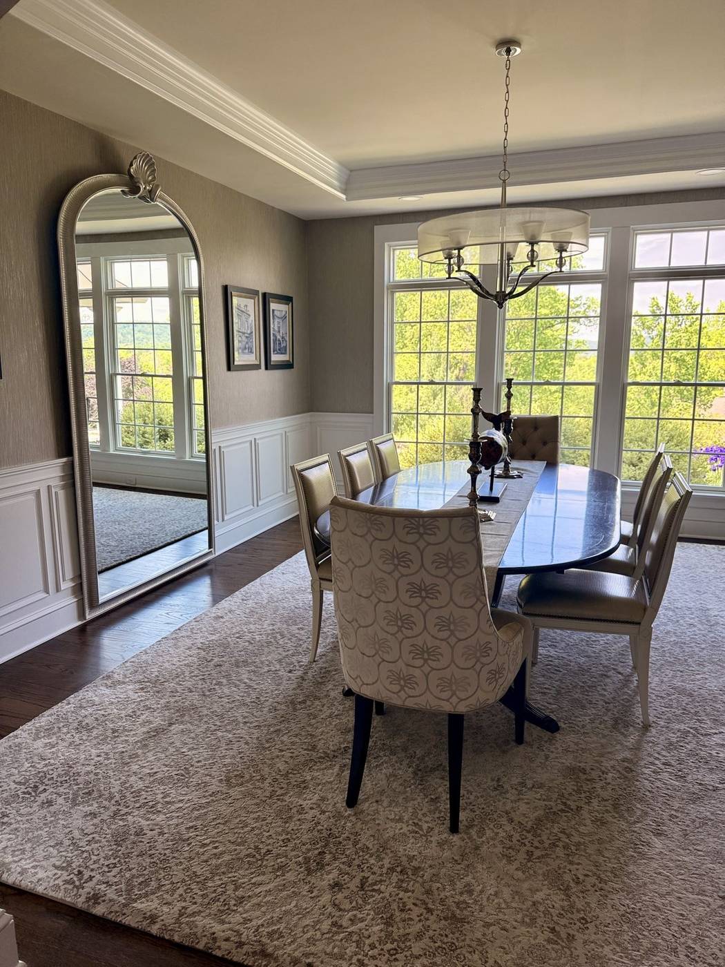 Clean dining room with a light wood table and area rug