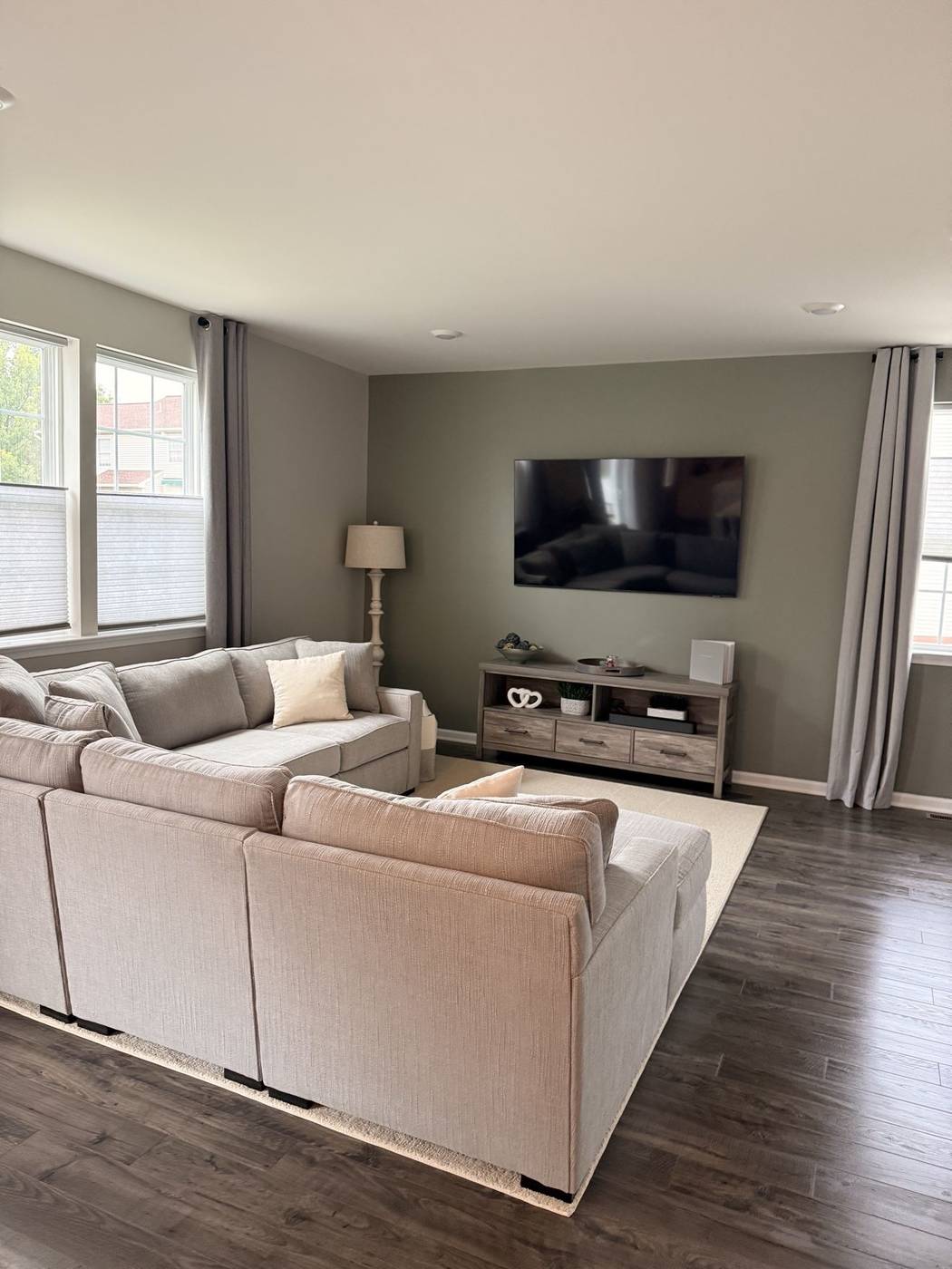 Clean living room with a neatly arranged sectional sofa