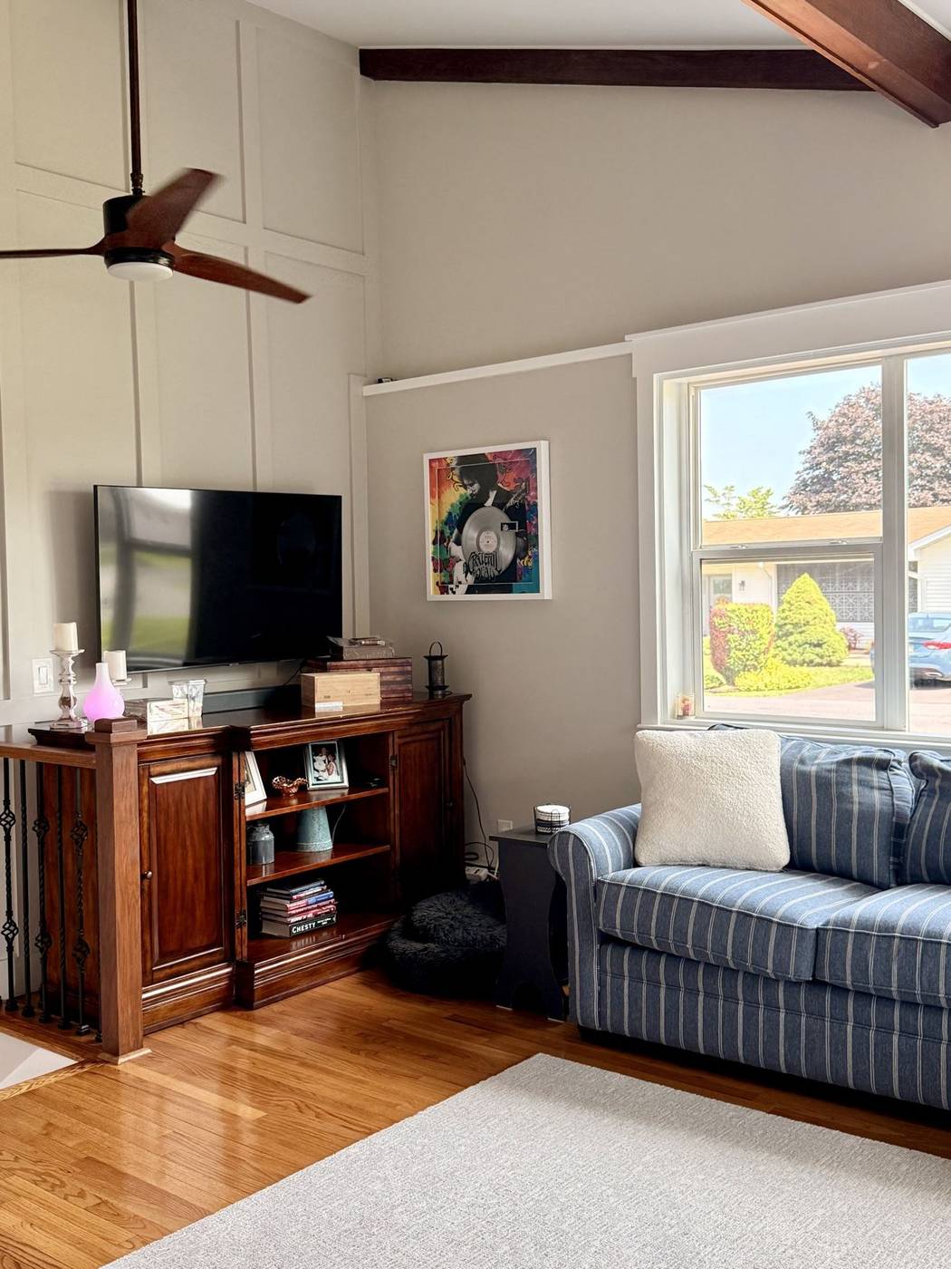 Refreshed living room with a striped sofa and television
