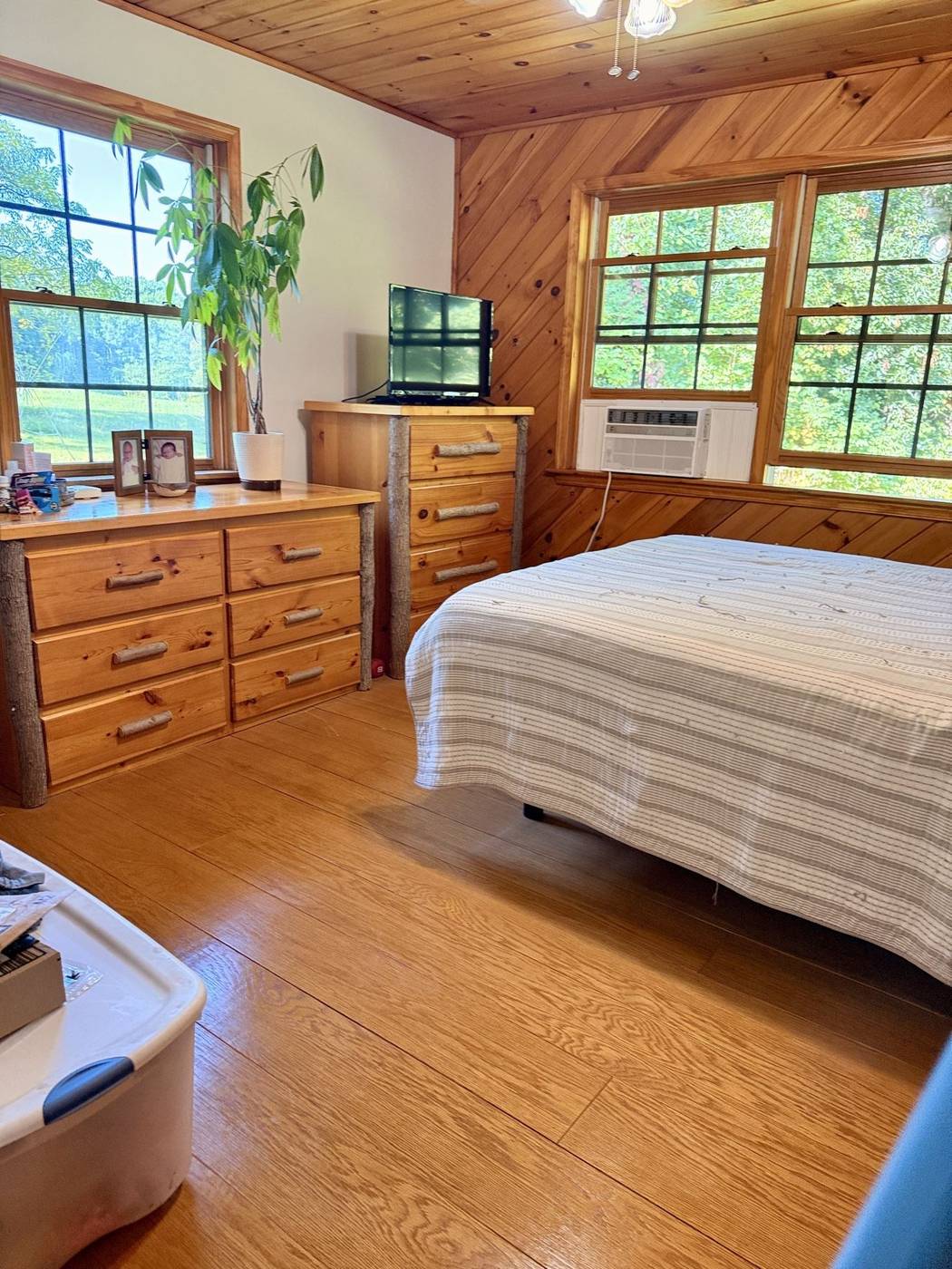 Clean and neatly arranged wood-paneled cabin bedroom