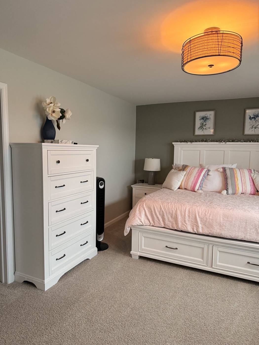 Tidy bedroom with a clean white dresser and hardwood floor