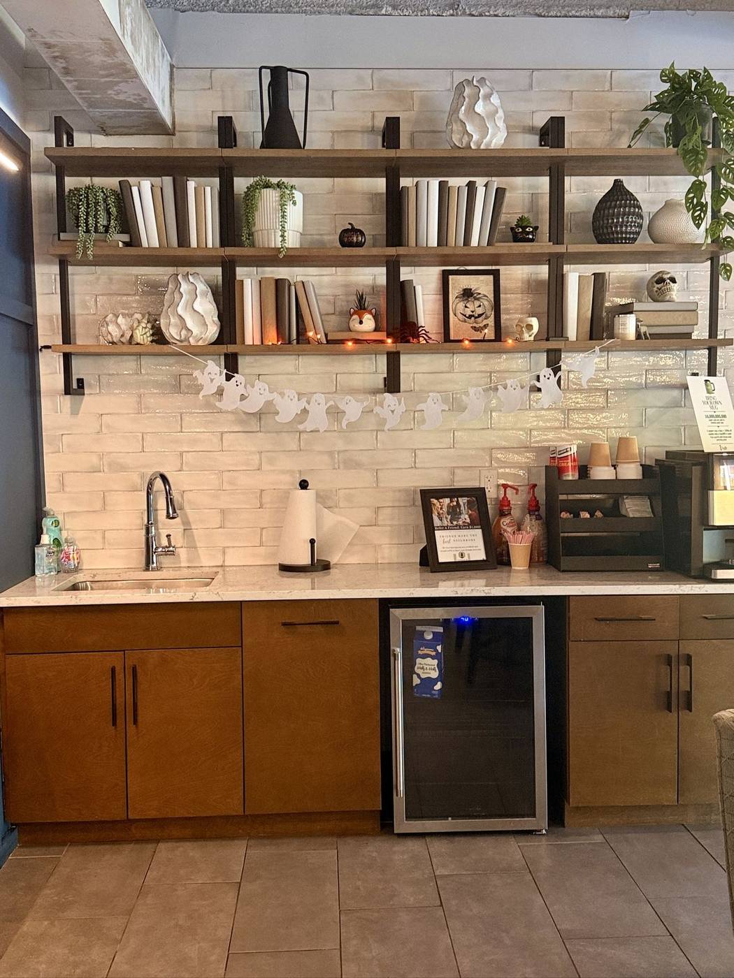Tidy commercial coffee bar with stocked shelving